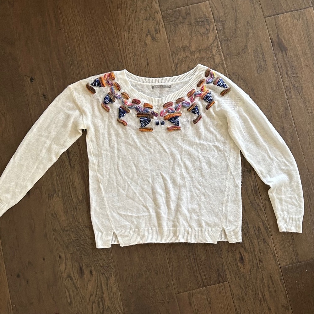 White sweater with embroidery detail